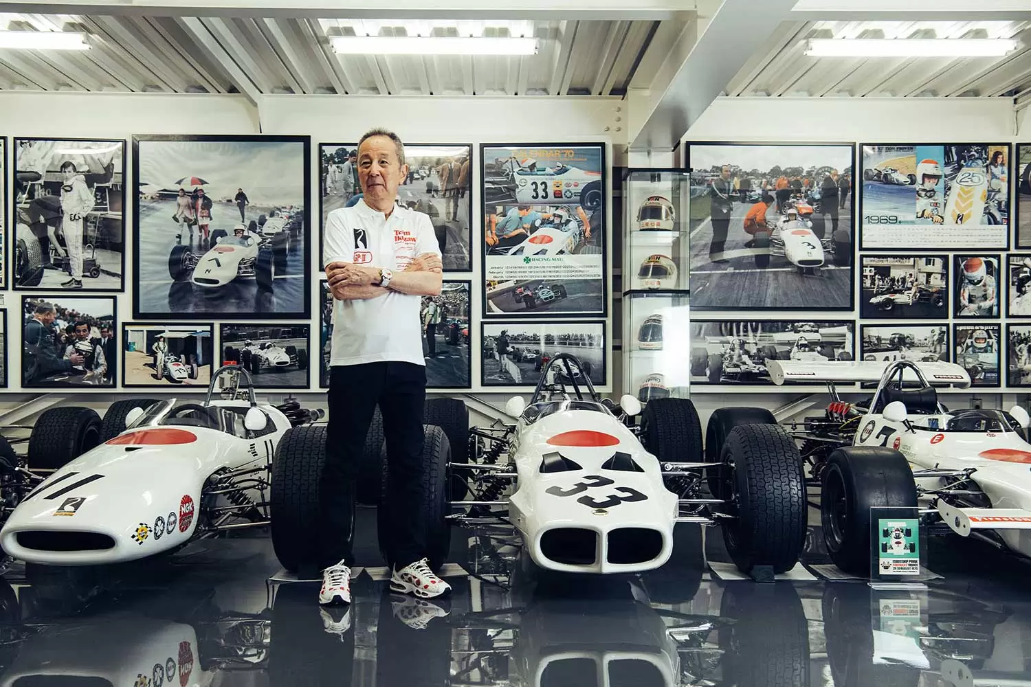 Tetsu Ikuzawa with historic Japanese racing cars and photographs